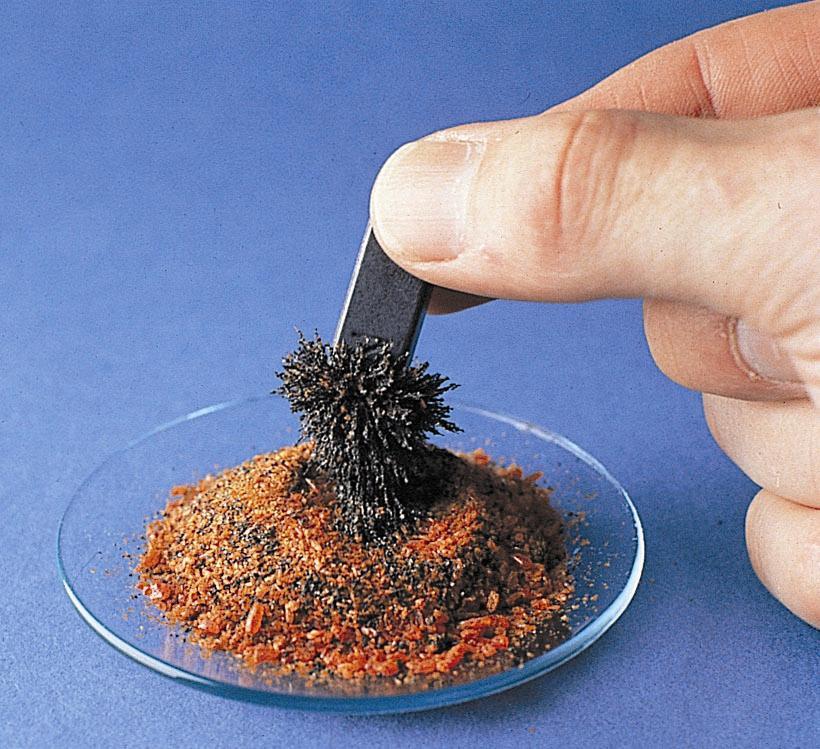 Figure 1.15: A magnet separates the iron filling from the mixture. Photo courtesy of James Scherer.