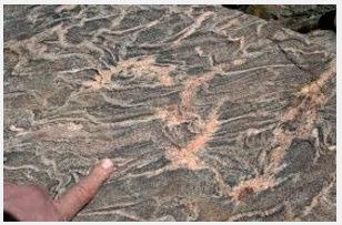 It is formed by the metamorphosis of granite, or sedimentary rock.