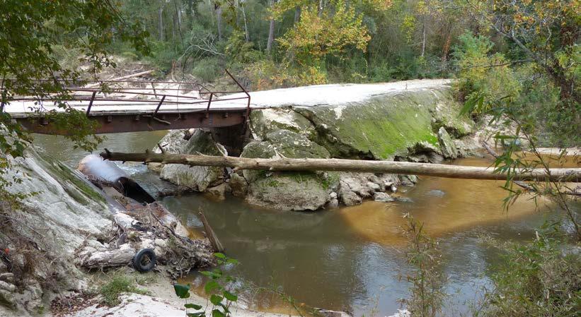 The previous stops have looked at the morphology of a stream under natural conditions. At Stop 3 a bridge has been built across the creek and has modified the natural process.