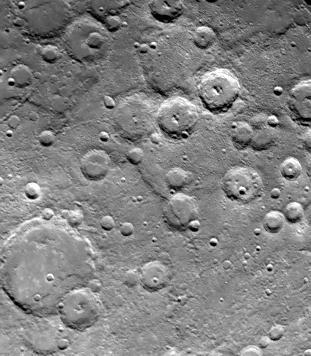 The heavily cratered regions are not as densely cratered as the Moon: