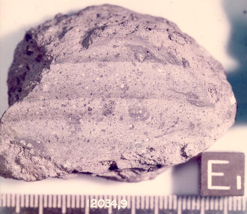 12034 Regolith Breccia 155 grams DRAFT Figure 1: Lunar sample 12034 after first saw cut in 1970. NASA S75-34235. Cube is 1 cm.