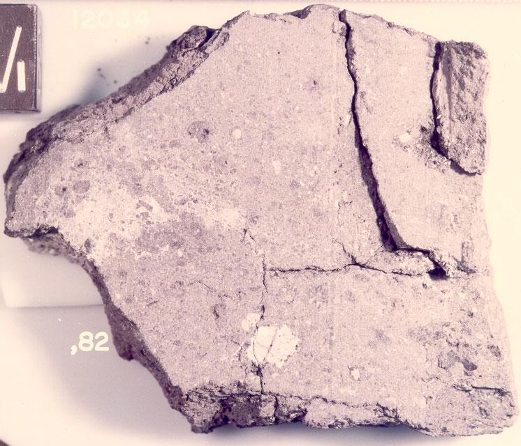 Figure 12: Slab (,82) cut from 12034 side facing (,80) end. NASA S 75-34236. Cube is 1 cm. McGee P.E., Simonds C.H., Warner J.L. and Phinney W.C. (1979) Introduction to the Apollo Collections: Part II Lunar Breccias.