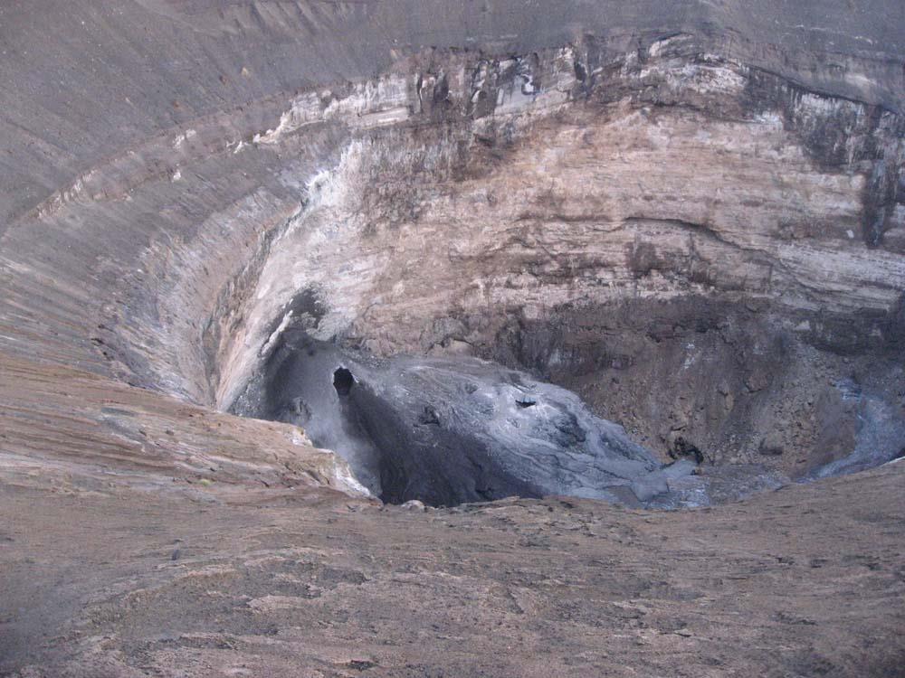 Figure 3. A tall spatter cone was formed 10 April 2013 near the crater wall, as seen looking W from the crater rim, located on the W side of the pit.