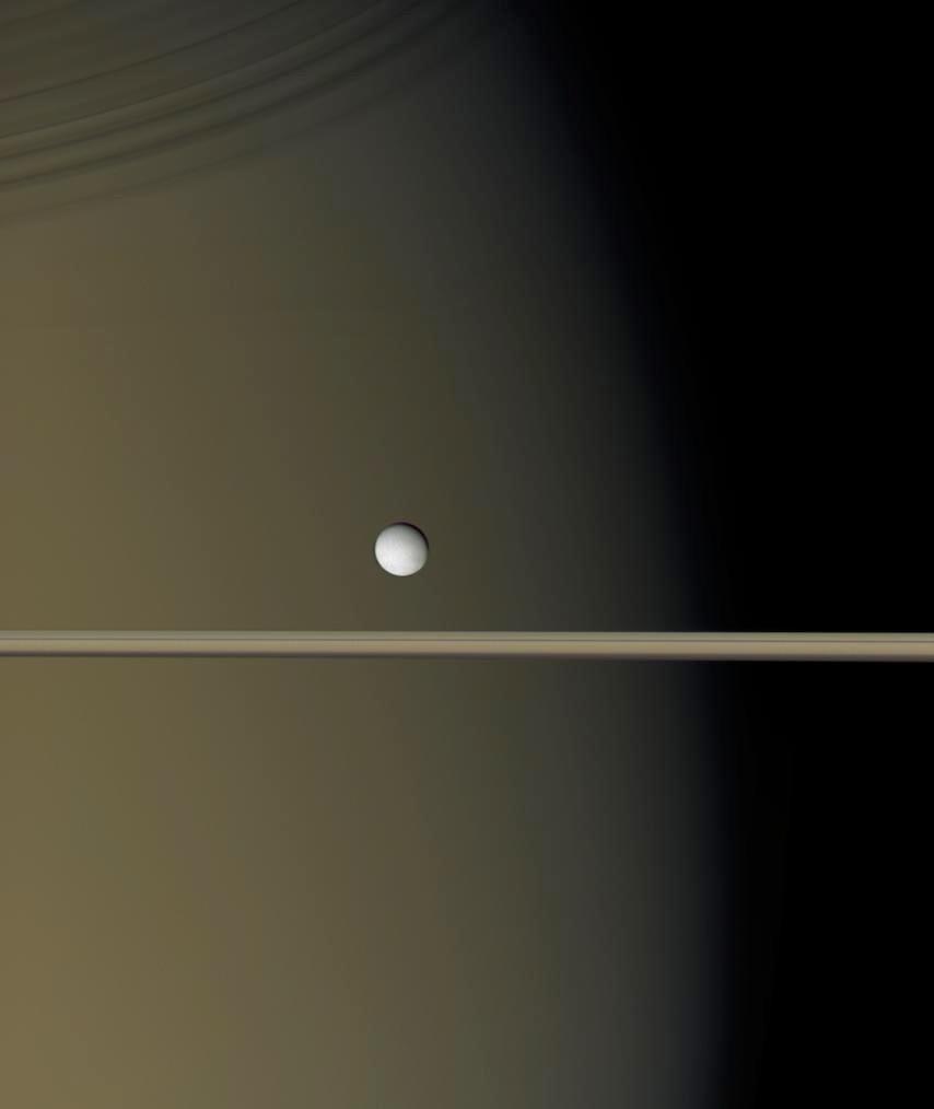 1 Enceladus This image, acquired by the Cassini spacecraft, captures Saturn, its rings (edge on), and the moon Enceladus.