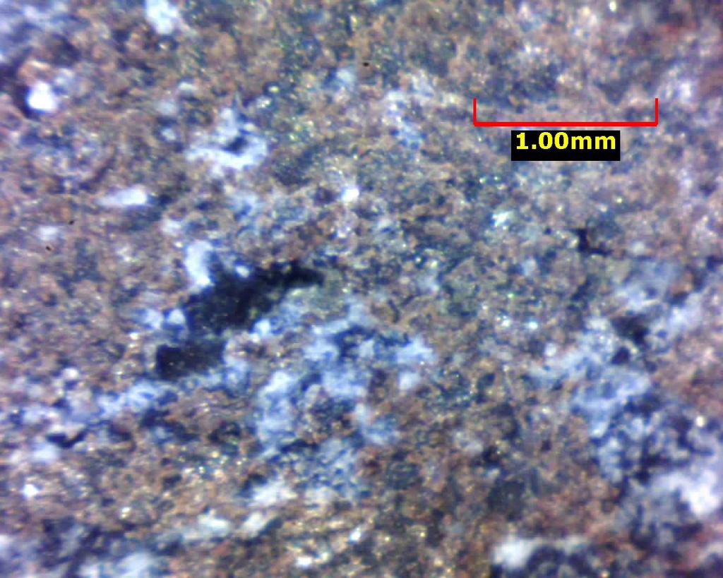 Figure 38. DDH SXL-4 @ 297.0. Showing internal structure of reddish sphalerite lamina with brecciated(?) quartz pieces. Pyrrhotite is very fine-grained.