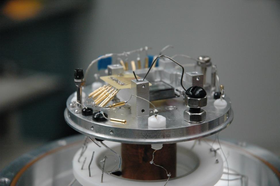 Appendices Figure C.2. A photograph of the baseplate inside the cryostat with a mounted and wired detector. The cryostat wall and infrared shield are removed.