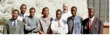 IMAGE, ABOVE, left to right: Donald Kamdonyo, Dir, National Meteorological Society; Martin Munkhanya, IEDRO volunteer; the meteorological society volunteer staff and behind, Ken Clark, former