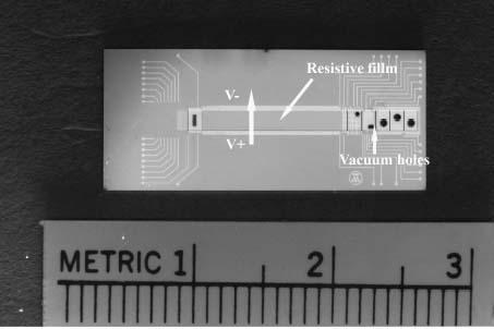 14 Figure 2.5. Micromachined Wien filter using a resistive film to form a uniform electric field, scale in cm, from [10]. The Wien filter fabricated by Sillon performed poorly.