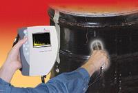 Figure 21. Hand-held identifier checks the contents of a drum.