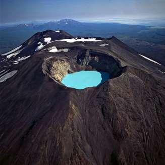 Craters Crater = A funnel-shaped pit at the top of a volcano During eruptions, lava and pyroclastic flows build up material around the