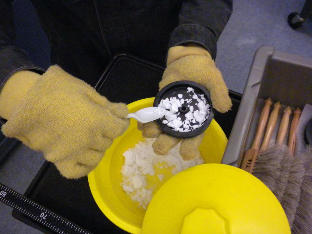 24 LAB I. 2D MOTION Figure I.3: Filling the puck with dry ice. Use gloves and a plastic spoon to avoid injuries. 2. Make sure that the table of cleared of any debris.