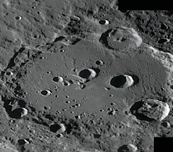 It spans 63 miles (101 kilometers) and has one of the darkest crater floors on the Moon.