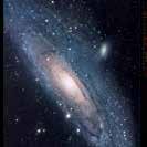 Two small images show Andromeda s stars in optical (top) and its gas in