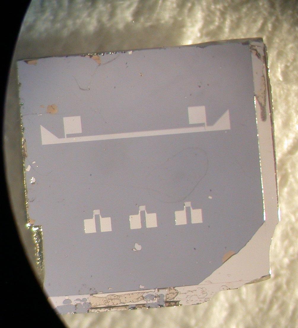 D. Bagliani et al. The detectors patterns were designed as in fig.1(a) below in which the small square film of Ir is between two aluminum contacts wires coming from the big soldering pads.
