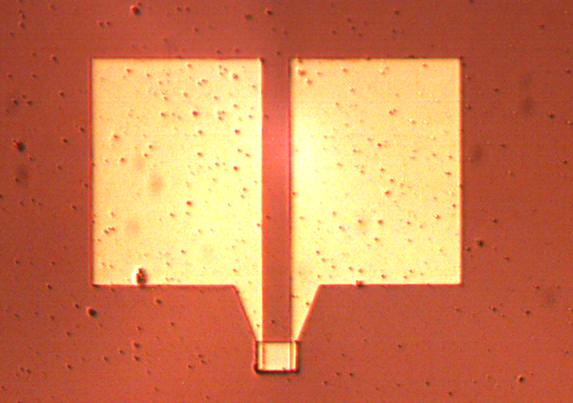 The strip is used to characterize the Ir film with a 4 wire measurement of R(T,I) in a well defined current flow.