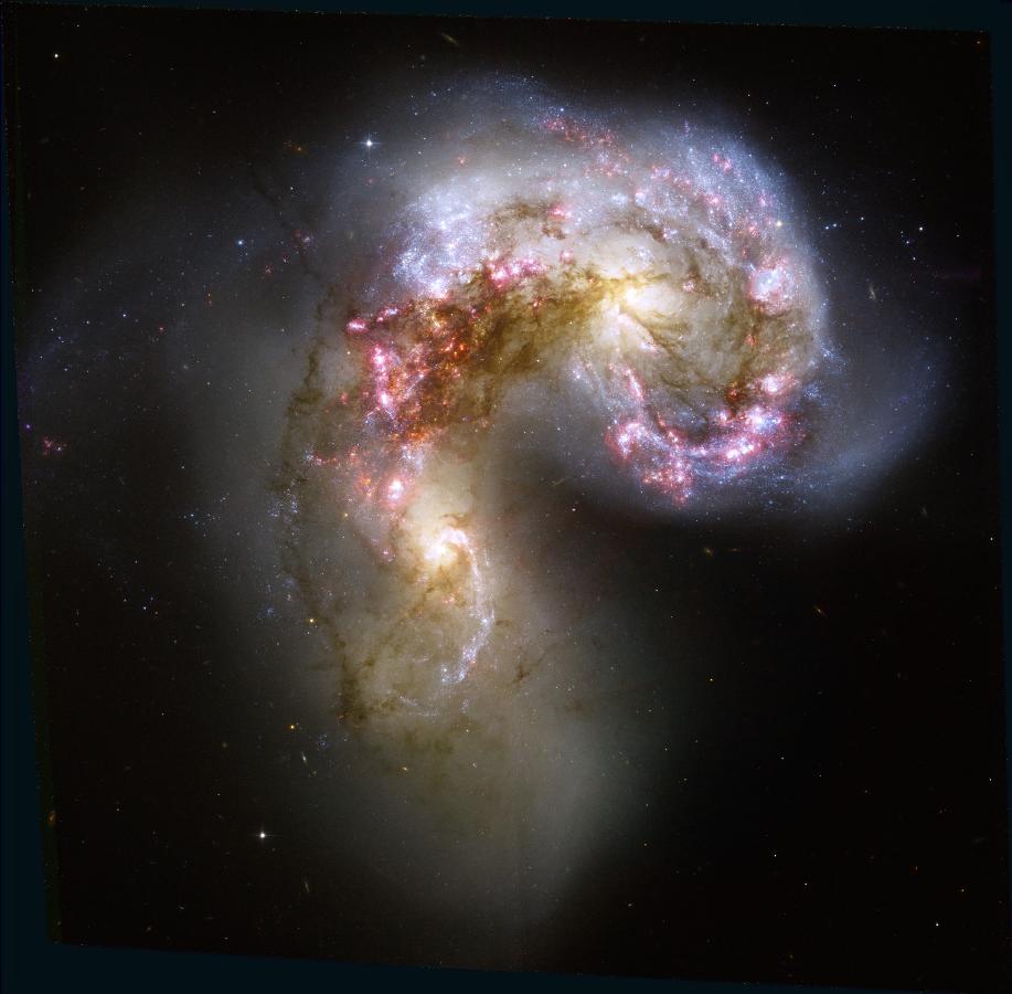 Figure 1: A multiband HST image of the Antennae, showing a rich population of young clusters and many other features associated with these merging galaxies.