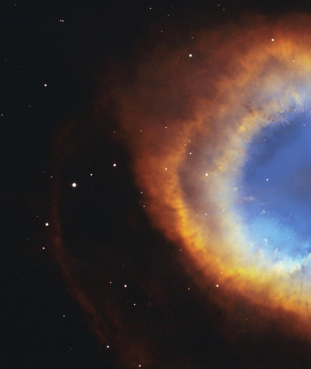 The Helix Nebula The image of the Helix Nebula shows a fine web of filamentary "bicycle-spoke" features embedded in the colourful red and blue gas ring, which is one of the