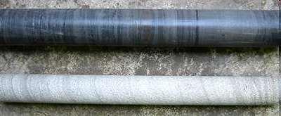 A Rock Core: A cylindrical section of rock that was drilled and contains a layered structure.