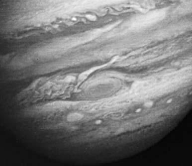 The clouds of Jupiter form bands that have very high winds and are always very stormy. Scientists believe one storm is like a huge hurricane. It is called the Great Red Spot.