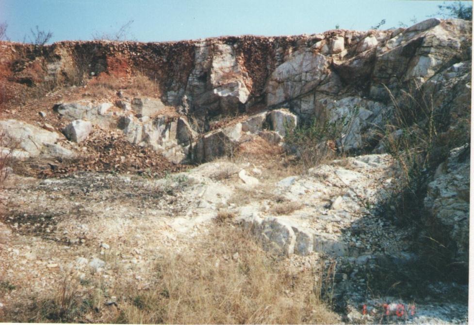 Photo 1: Quartz exposures occur as massive, semi-transparent and with three sets of joints. The quartz and feldspar veins in Kukatpally Quartz mine trend in N 60 o E.