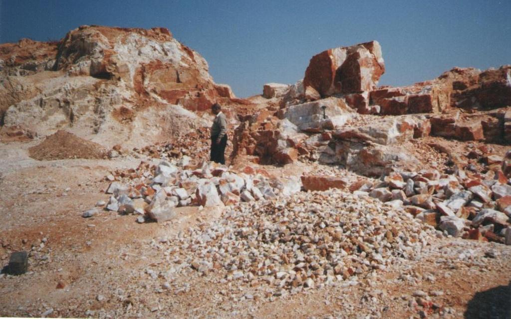 The thickness of soil cover in the existing mines is negligible and weathered feldspars with quartz pebbles are exposed on the elevated portion of the mound towards western side.