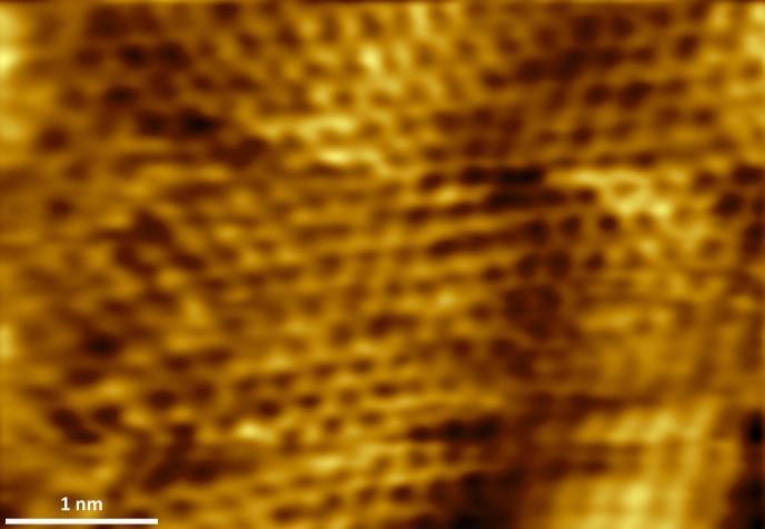 around the centre of the image. In two areas (top and bottom part of the image) it is even possible to observe the honeycomb graphene structure.
