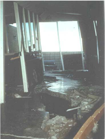 Interior view of building pulled apart by lateral spread, San