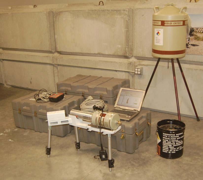 2. MODIFICATION OF THE PINS SYSTEM The PINS system as it is currently deployed by the U.S. Army and others uses a 252 Cf isotopic neutron source to excite gamma rays within the object under assessment.