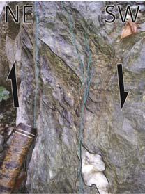 A) Mineral stretching lineations, defined by small mica and elongated feldspar minerals. B) Discrete shear zone, quartz veins turn into the shear zone.