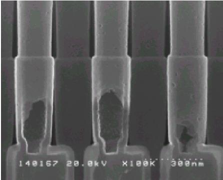 Top-view SEM images of (a) the landing pad and (b) OCS contact after the oxide inside the OCS had been etched out.