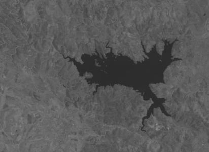 (a) Channel 4 of the Landsat-5 TM image acquired in September 1995; (b) Channel 4 of the Landsat-5 TM image acquired in July 1996; (c) available reference map of changed areas.
