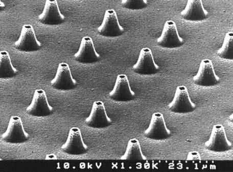 272 7 Indirect Nanofabrication Fig. 7.4 Scanning electron microscope photo of micronozzle array made by sidewall patterning onto a silicon base which has an array of cone-shaped structures.