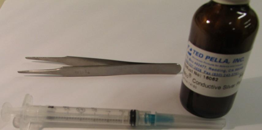 Figure 5: Silver paste and syringe for sample contacts f.) Let the silver paste dry for ~20 minutes before handling the sample. g.) While the silver paste is drying, the puck can be prepared.