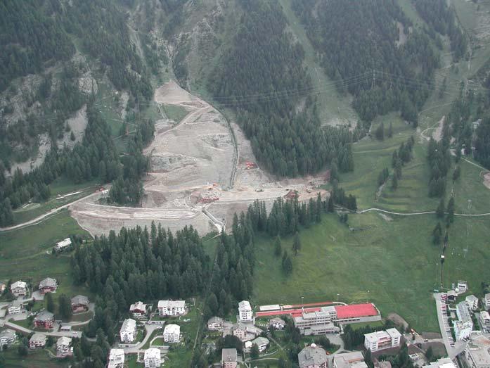 360 MARCIA PHILLIPS Figure 6. Combined avalanche/debris flow retention dam (under construction in 2003) protecting Pontresina at the foot of the Laviner Giandains gully. (Photograph: M. Hiller SLF).