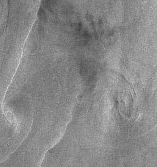 At wind speeds about 6 7 m/s, eddies appear in the SAR imagery as a result of wave/current interaction which either outlines the shape of the eddy by bright (less often dark) linear features or