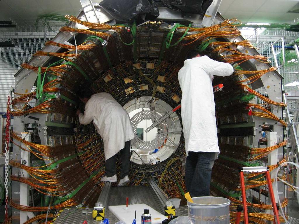 3: Illustration of the CMS tracker and photograph of installation of the TOB to the support tube (courtesy CMS TOB team).