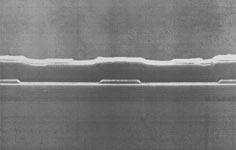 (a) (b) Fig. 12. Scanning electron micrograph of the cross section of a buried heterostructure laser grown by SAE. B.