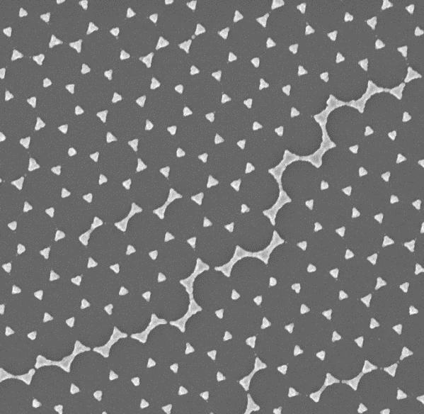 Nanosphere lithography (NSL) was used to fabricate arrays of isolated nanoparticles on glass substrates.