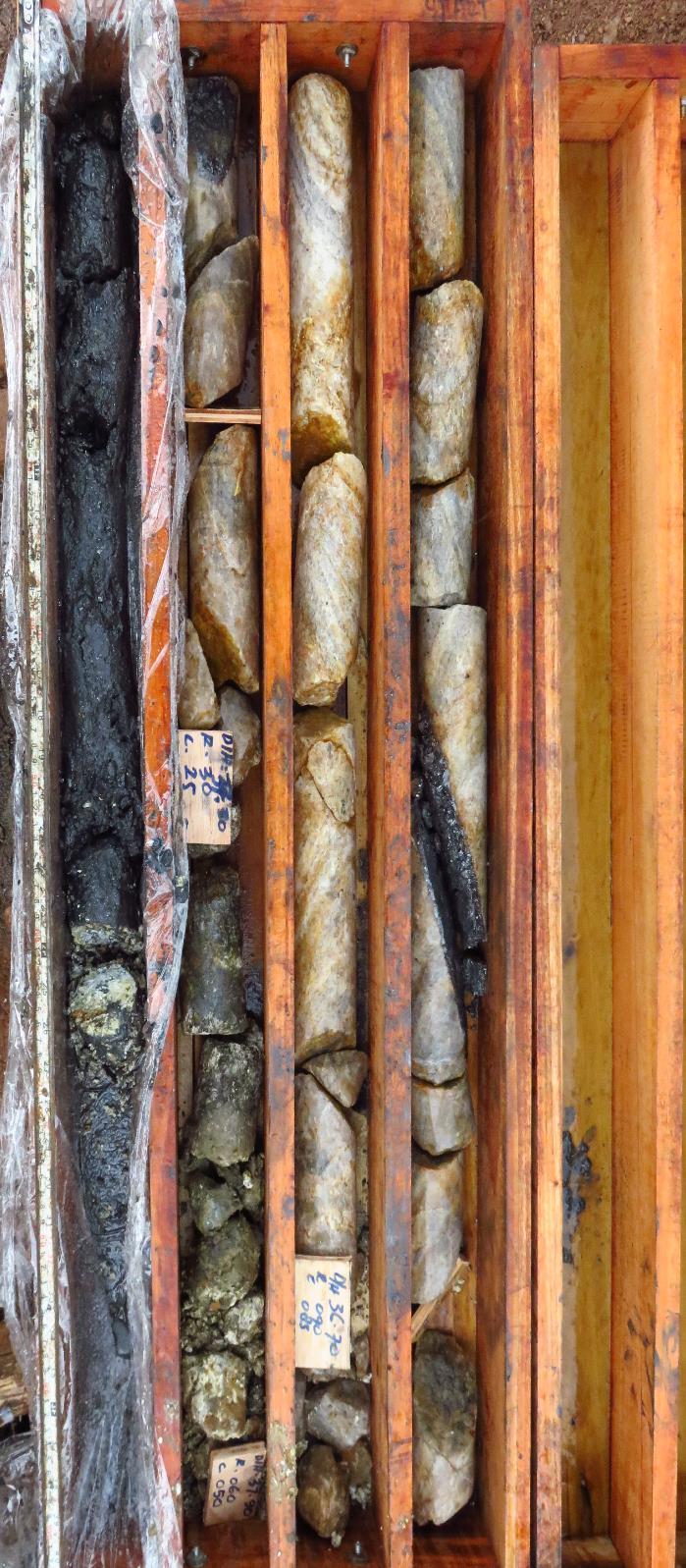 interbedded with host rocks, extends over an interval of 15m from a depth of approximately 50m downhole.