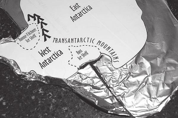 5. Starting with the Antarctic peninsula, roll and pinch the outer edge of the foil upward to make a foil wall ¼ to ½ inch high along both sides of the peninsula. 6.