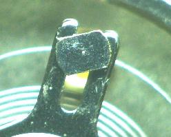 2) Rotate the STUD in order to align the position of the balance-spring passes through the center of the slot of the