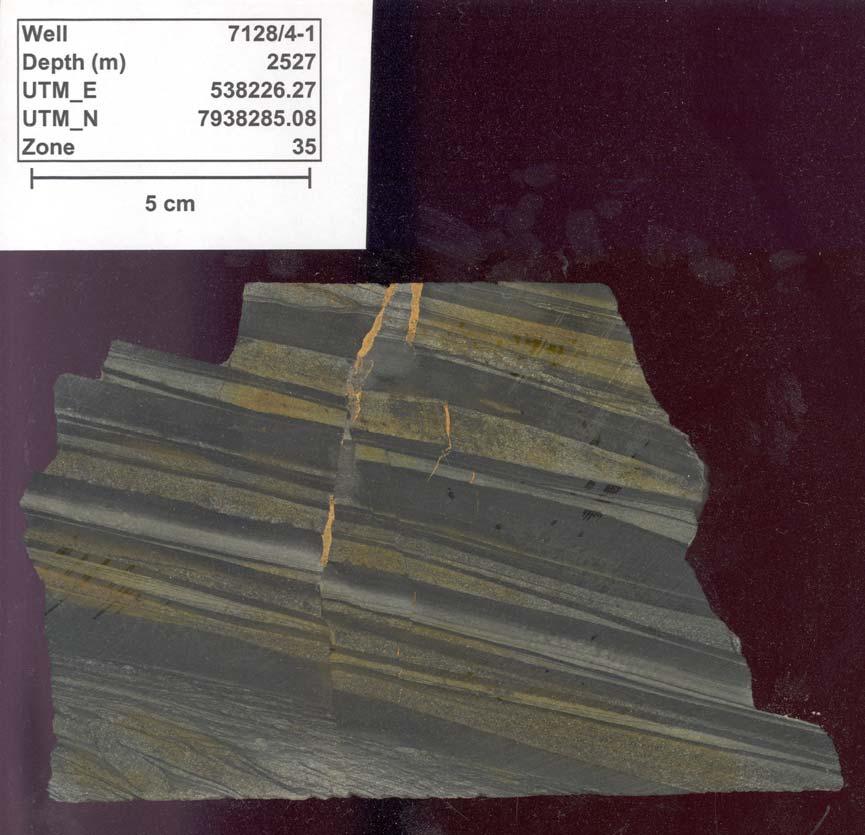 7128/4-1, 2527.0m Finnmark Øst area, Barents Sea Laminated shaly siltstone, with upward-fining layers of fine-grained sandstone (at base) through siltstone to shale (at top).