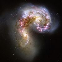 The process typically takes millions if not billions of years. The Antennae Galaxies are a dramatic pair of colliding galaxies.