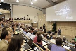 Joe Incandela, spokesperson of the CMS experiment, addresses a scientific seminar to deliver the latest update British physicist Peter Higgs arrives for a press in the search for the Higgs boson at