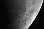 Moon The same side of the Moon always faces Earth because the lunar periods of rotation and revolution are the same. The surface of the moon is covered with impact craters and lava filled basins.