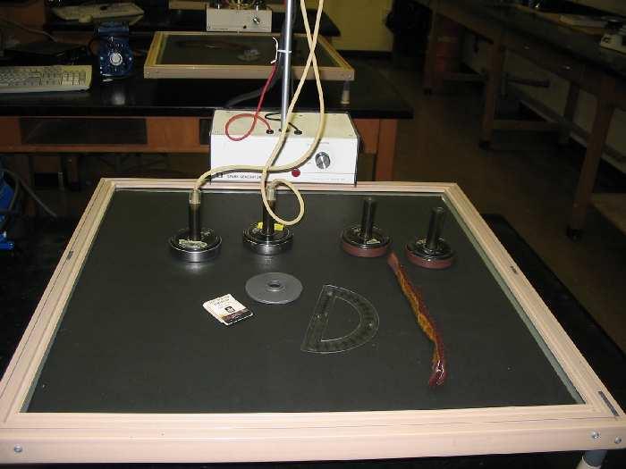 Figure 7.3: The air table with various components used in the experiment. In addition to equations 7.7, 7.8, and 7.