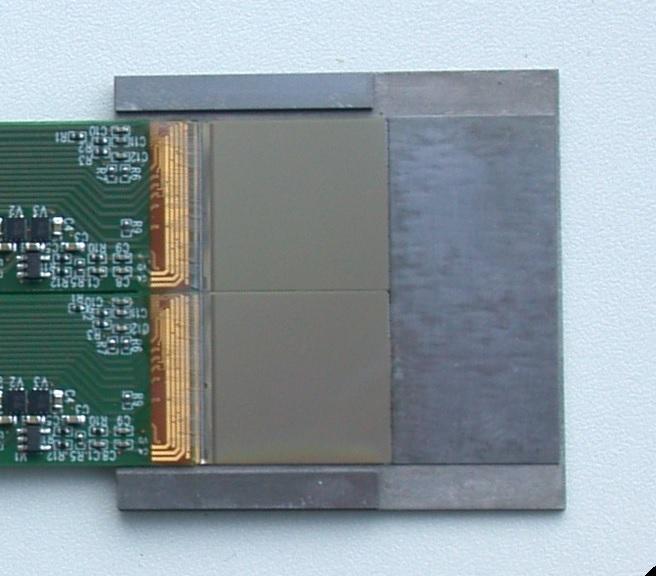 Right: a picture of a single prototype module. To this end the gap is filled with tungsten filler plates. The thickness is chosen such that the sensors are protected from physical damage.