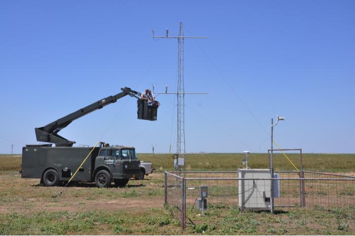 Figure 1. Kevin Heflin and Jack Bush (Research Associates) troubleshoot 2-D sonic anemometers and temperature/rh sensors mounted on Tower 1 on the west end of the monitoring area.