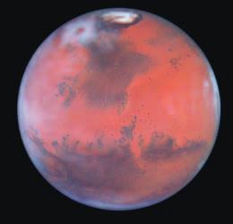 Figure 29-12 This view of Mars, taken by the Hubble Space Telescope (HST), shows its surface, its atmosphere, and one of its polar caps.