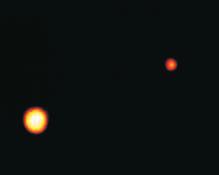 Figure 29-25 This image of Pluto and Charon, taken by HST on February 21, 1994, is the best image to date of the pair. Pluto and Charon are separated by a distance of 19 640 km.
